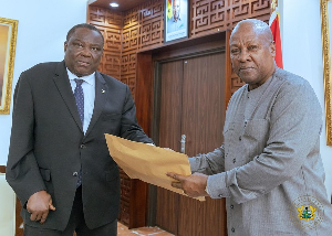 Chairman of the committee, Justice Pwamang presenting the report to President Mahama