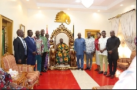Otumfuo Osei Tutu II in a photo with some officals from GIADEC