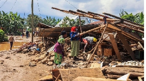 Citizens try to save their belongings after landslides triggered by heavy rains in Rubavu, Rwanda