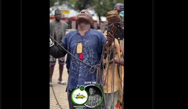 A priest performing rituals to hold back the clouds during the funeral of Asantehemaa