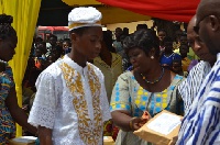 The headmaster making a presentation to Safana Muhaymine Guro