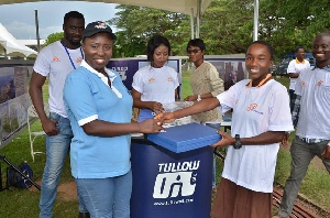 A participant receiving her prize from Tullow Ghana official