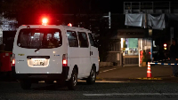 A police car drives into a rubber factory run by Yokohama Rubber Co in Mishima
