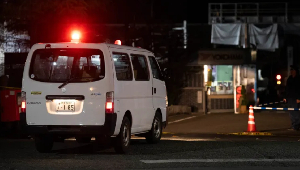 A police car drives into a rubber factory run by Yokohama Rubber Co in Mishima