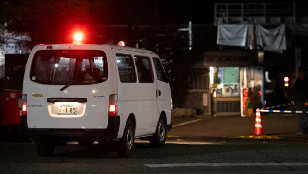 A police car drives into a rubber factory run by Yokohama Rubber Co in Mishima