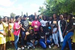 Members of GALs World in a group picture with some of the students