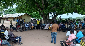 Atta Boateng (in brown) interacting with the Abamba community
