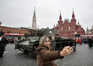 A woman poses for photos at outdoor exhibition commemorating the military parade in 1941 at Moscow