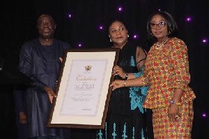 Mrs Rebecca Akufo-Addo receiving a citation from Minister for Business Development, Mohammed Awal
