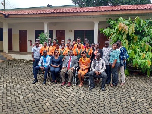 Dr Nii Moi Thompson in a group picture with staff and students of Vilac Int. School