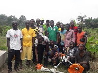Some farmers in a group photo with the brush cutter