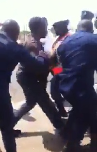 Police manhandling a man on the streets