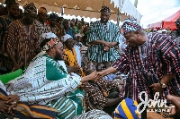 An Overlord shakes hands with John Dramani Mahama