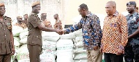 Dr Owusu Afriyie Akoto handing over some bags of fertiliser to Mr Patrick Darko Missah