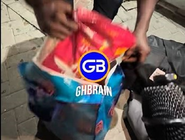 One of the returnees showing the package to the media