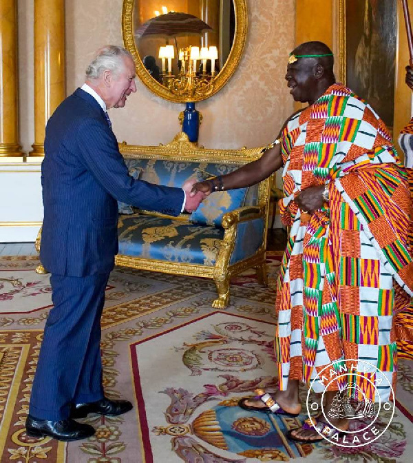 King Charles III on the left shakes hands with Otumfuo Osei Tutu III on the right