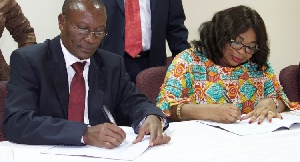 Makove and Lariba Bawa simultaneously signing the MoU