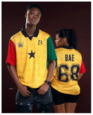 Two individuals adorned in the iconic Ghanaian jersey