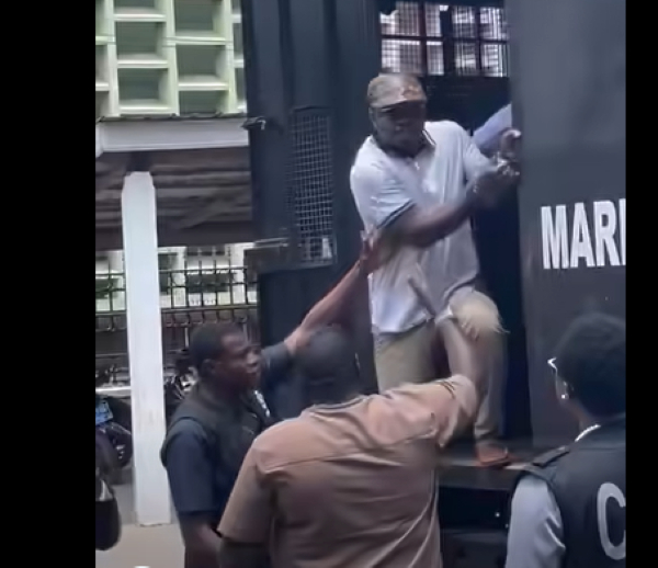 Kwame Baffoe Abronye being escorted out of the 'Black Maria' van