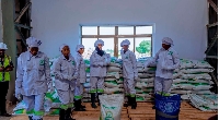 Workers displaying bags of sugar at Mkulazi Factory site in Tanzania