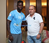 Cosmos Dauda with a club official