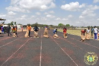 Some men and women in a sack race contest