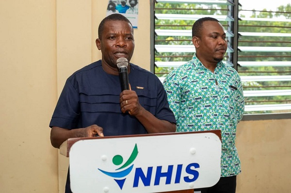 Reverend Martin Amenaki, Ketu North Municipal Chief Executive commending NHIS