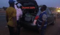 The ballot boxes being put in the booth of the car by the electoral officers.