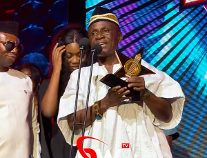 Abusuapanyin 2Pac captured on stage receiving an award on behalf of Daddy Lumba