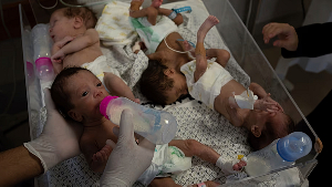 Medics prepare premature babies for transport to Egypt after they were evacuated from Shifa Hospital