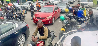 Nigerians, some pictured here in Lagos, are spending hours at petrol stations due the shortages