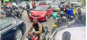 Nigerians, some pictured here in Lagos, are spending hours at petrol stations due the shortages