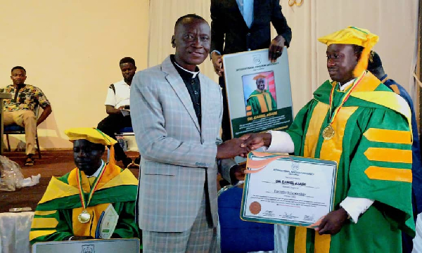 Dr Daniel Asare receiving a recognition