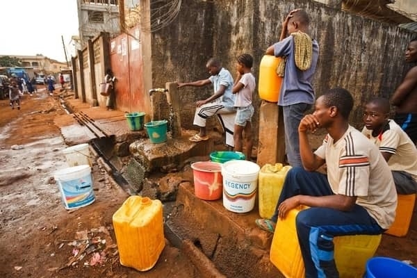 Some children filling containers with water