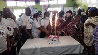 Participants who were at the commissioning cutting a cake