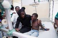 Stonebwoy interacts with a patient during his visit