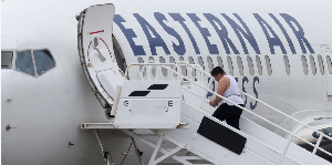 A detainee in restraints boards an aircraft used by ICE at the Salt Lake City International Airport