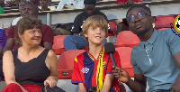 Shaban Mohammed (R) and young football fan with his mother (L)