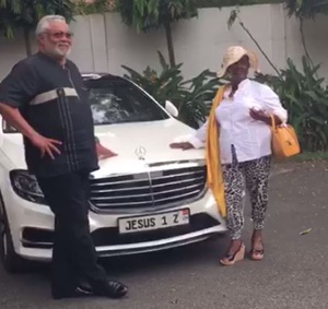 Ex president JJ Rawlings poses by the car with an unidentified woman