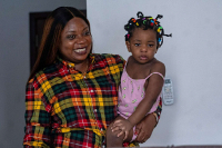 Gloria Masanka, a mother of two daughters, spends time with her younger daughter at home in Kinshasa