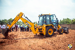 Rev. Dr. Wengam (in the Back Hoe assisted by Mr. Kutortse) to perform the sod cutting