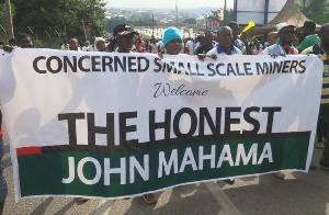 The Concerned Small Scale Miners Association marching with their banner