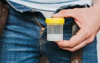 File photo of a man holding a container filled with semen - photo credit: Istock