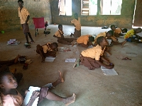 Some students of the  Kparigu Primary School learning on the floor
