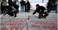 Victims' names are painted on the ground outside the courthouse