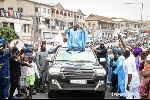 Dr. Mahamudu Bawumia waving at the crowd on the streets of Kumasi
