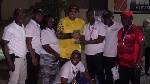 President of Ghana minigolf federation presenting the trophy to the winner Forbes club