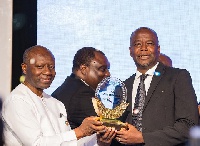 Samuel Koranteng being presented with GC100 plaque by the the Minister of Finance Ken Offori-Atta