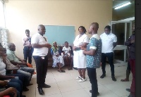 External Affairs Director at Vodafone Ghana, Gayheart Mensah briefing a Nursing Officer at Korle bu
