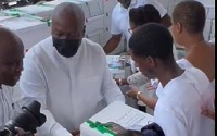 President-elect John Dramani Mahama distributing food to church members